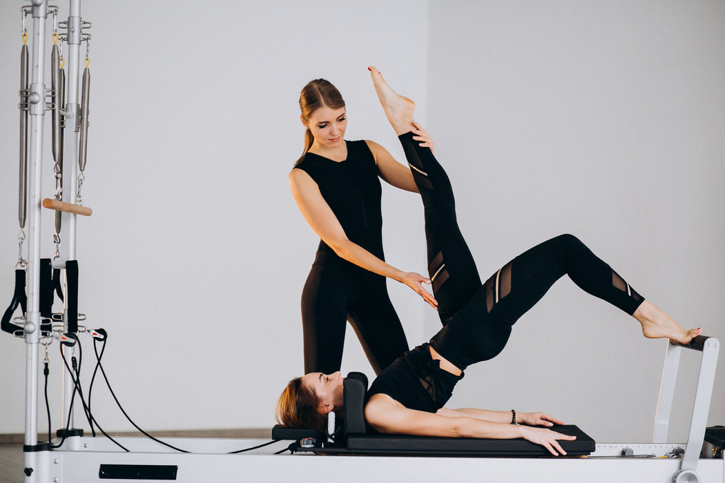 Women doing pilates on a reformer